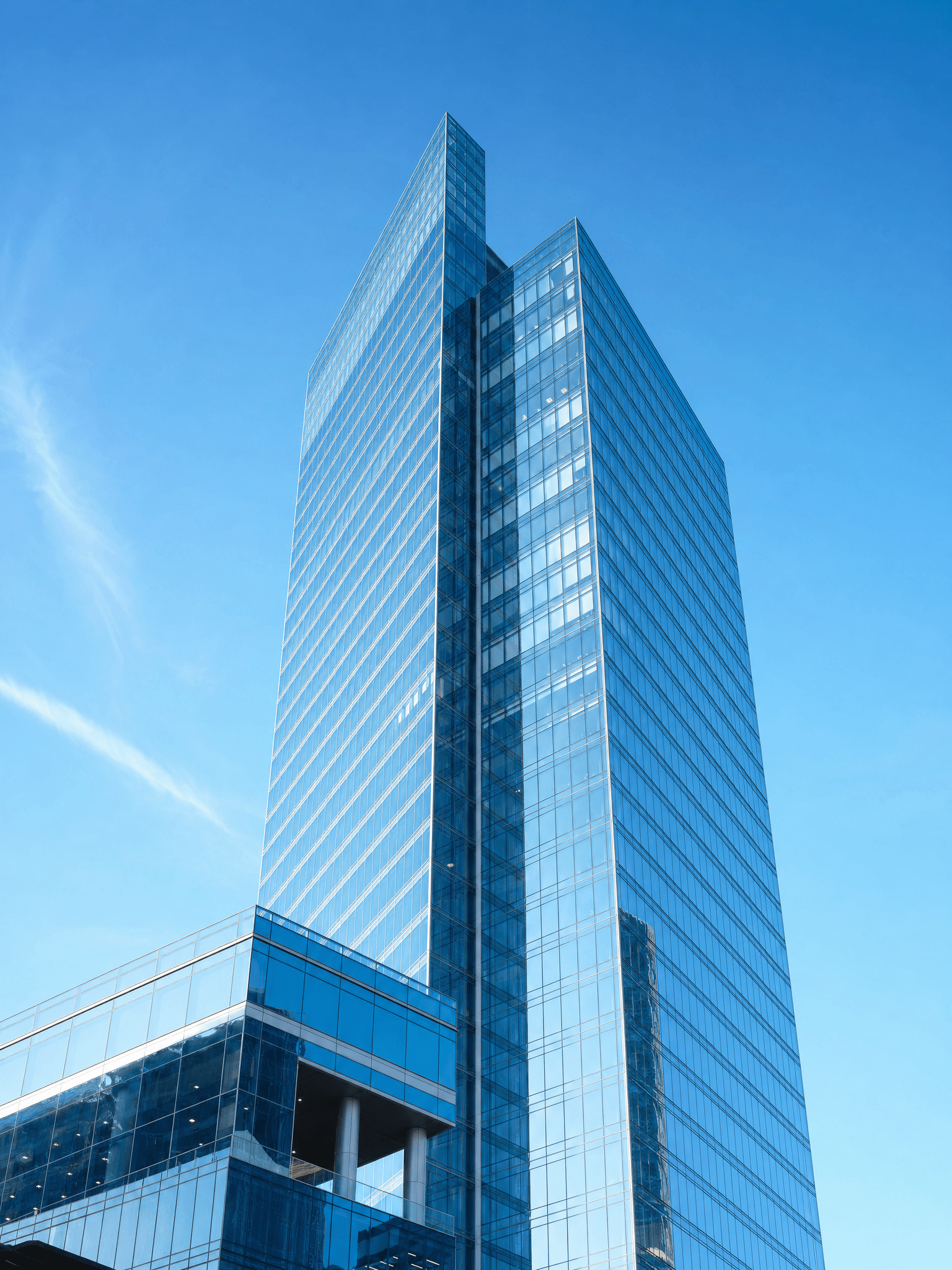 Glass skyscraper against a clear blue sky